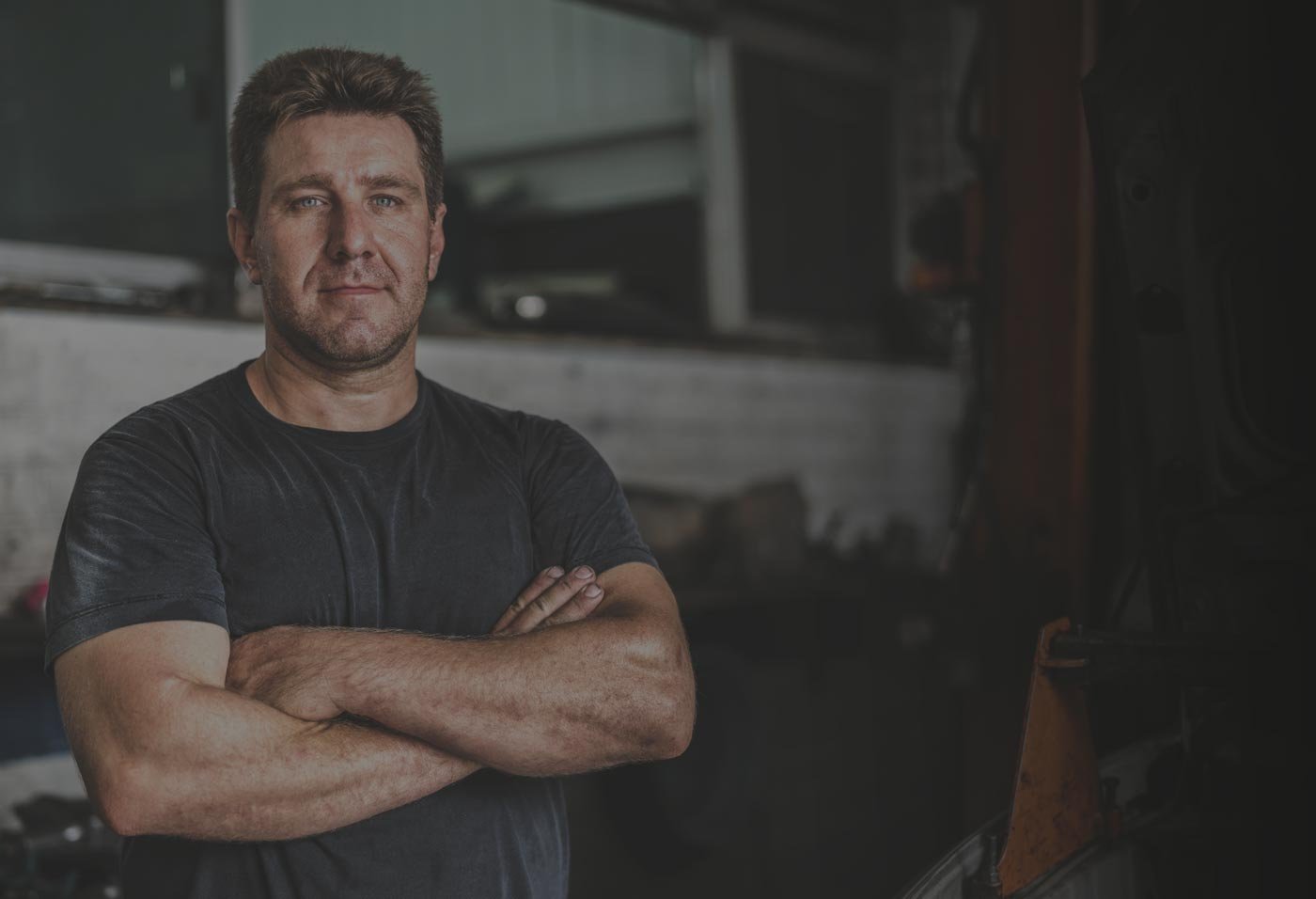 shop owner with arms crossed in shop