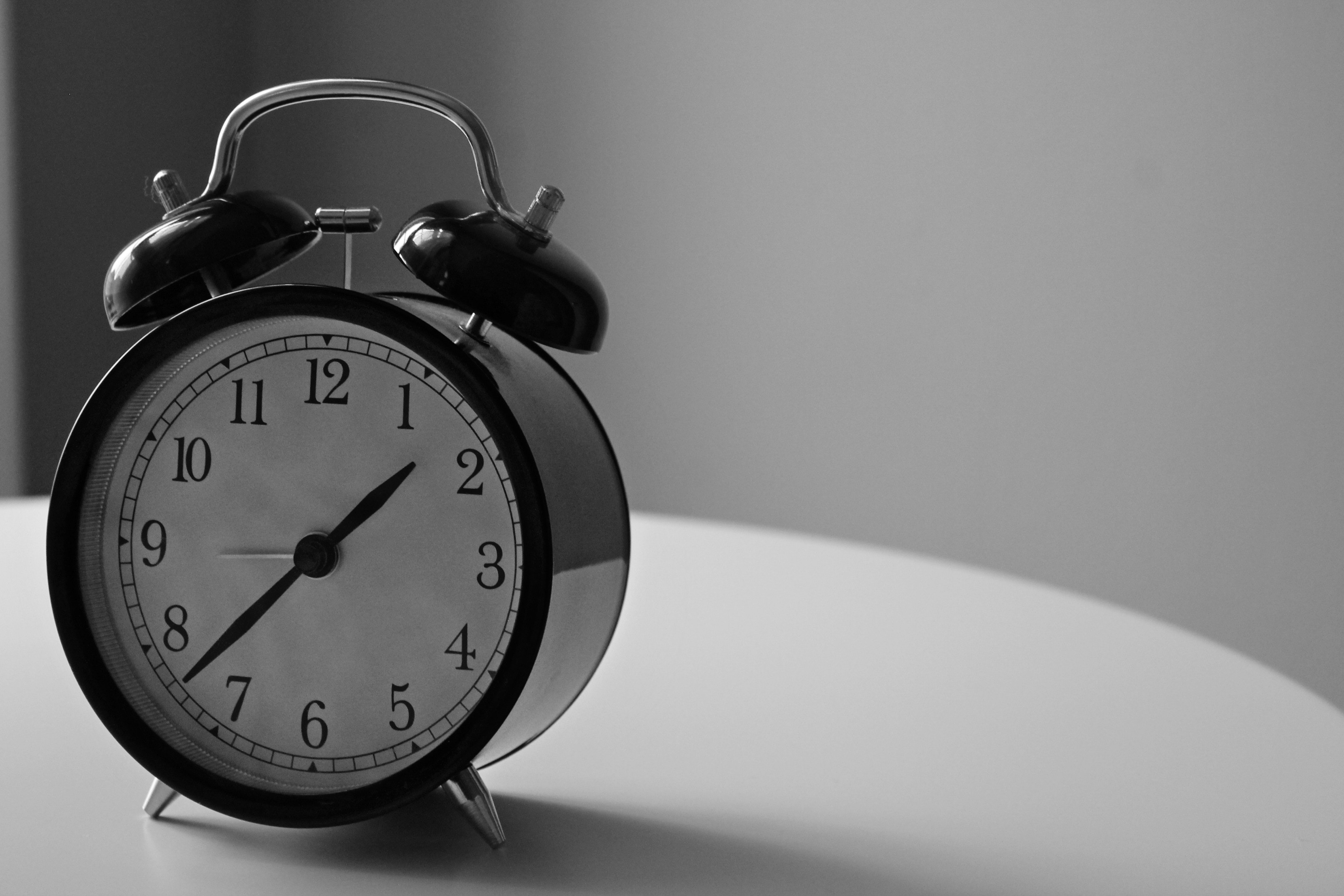 black and white photo of an old alarm clock