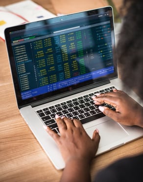 person on laptop at wooden table